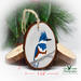 A three inch diameter wood slice with a hand-painted bird at Cove Creek Photography.